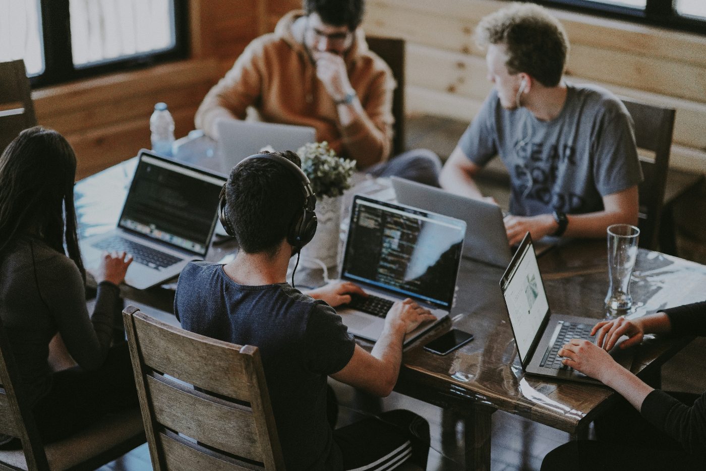 A product team working together on laptops around a shared table